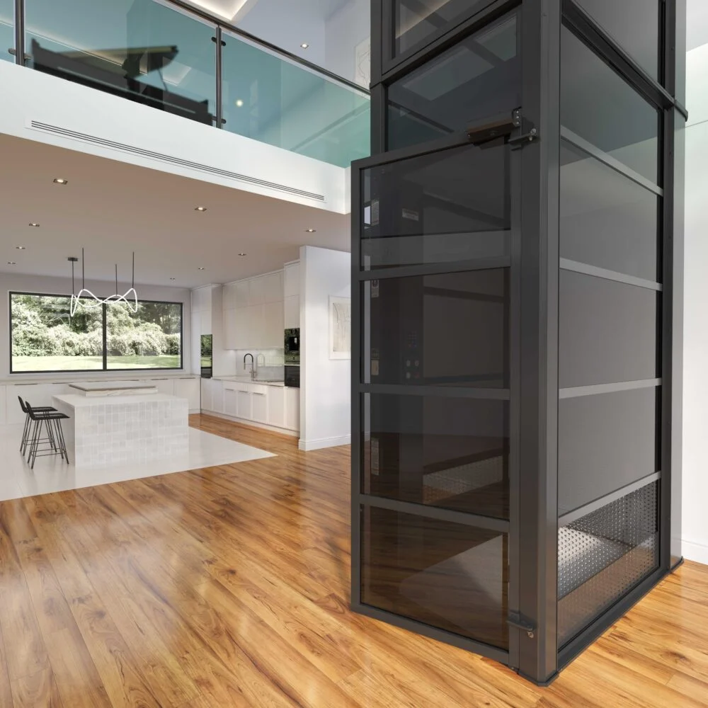 The Cube residential elevator with smoked glass and dark frame in an open plan home with wood floors