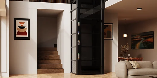 Black framed home elevator installed beside staircase in modern living room