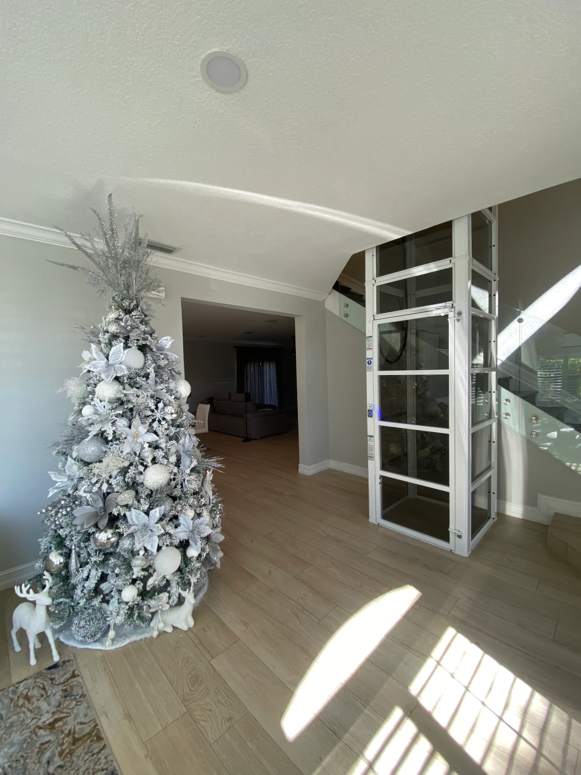 White Cube home elevator installed beside a staircase