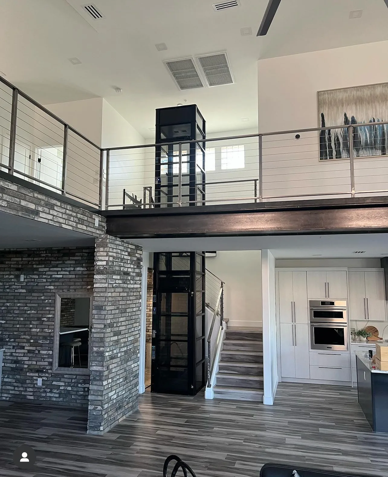 Black Cube home elevator connecting the kitchen and the loft in an open plan home