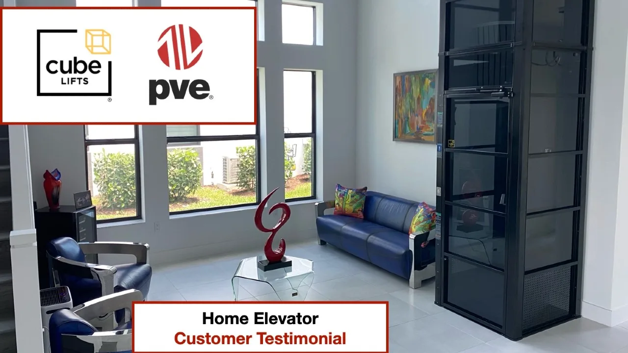 Living room with black glass home elevator installed, sofa and decor, Cube Lifts and PVE customer testimonial